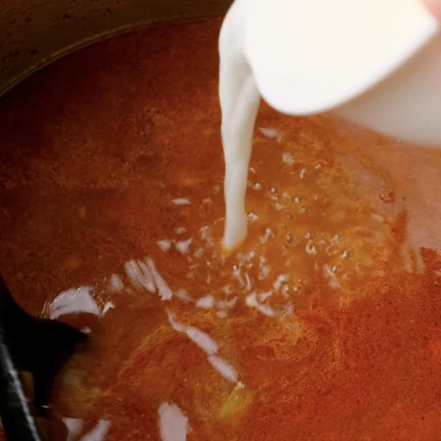 Cornflour slurry being added to thicken instant pot roast beef sauce.