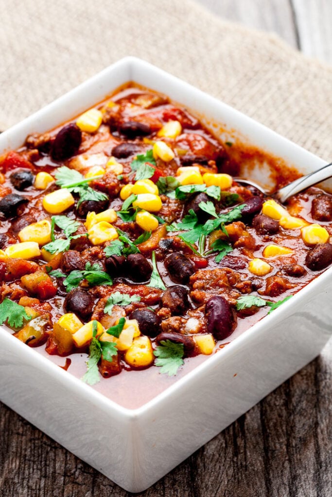 slow cooker chili with black beans and corn in white bowl