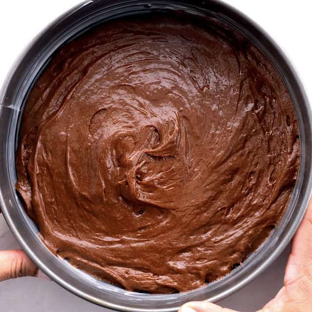 Bottom layer of triple chocolate mousse cake in a springform pan.