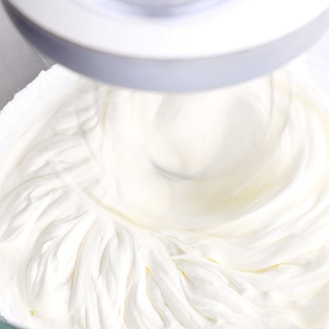 Cream being whipped until soft peaks to make triple chocolate mousse cake layer.