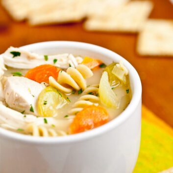chicken noodle soup in white bowl