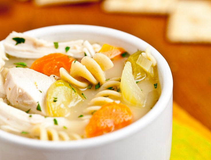 chicken noodle soup in white bowl