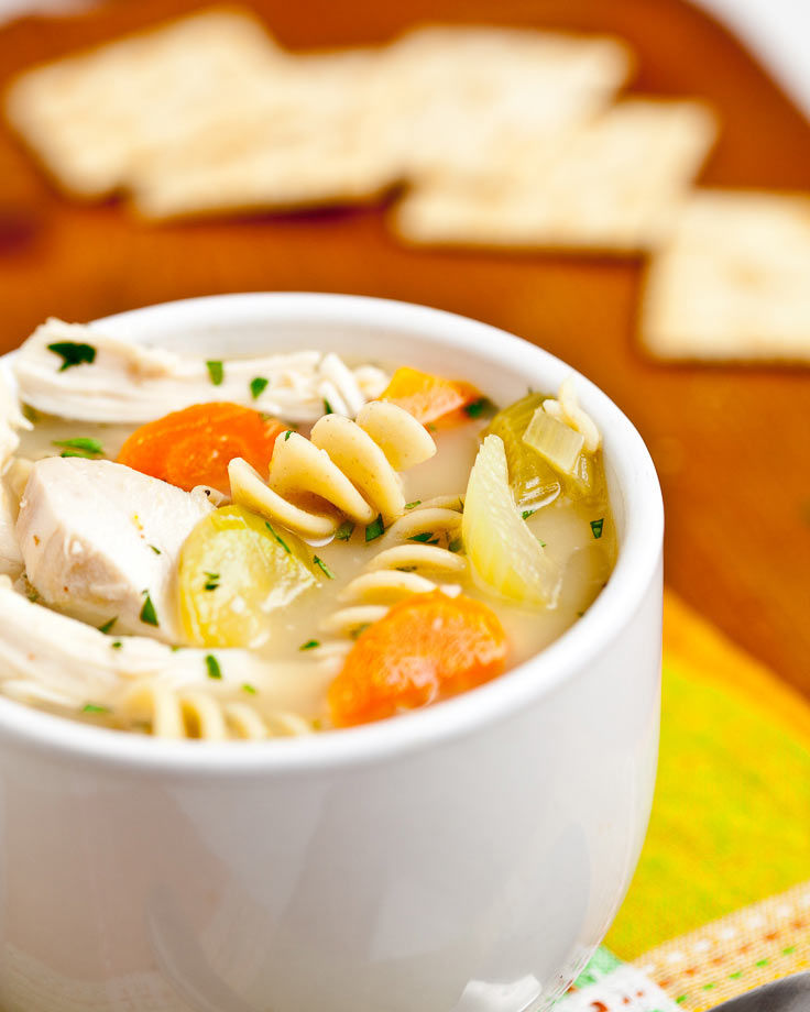 chicken noodle soup in white bowl