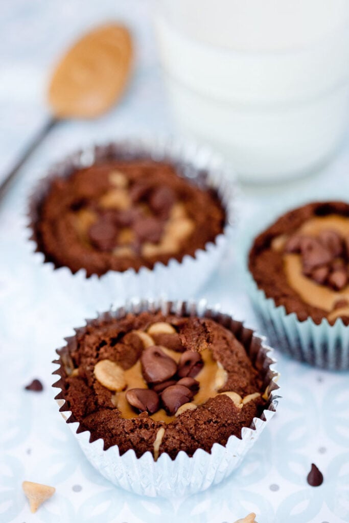 brownie peanut butter cups in muffin tins with glass of milk