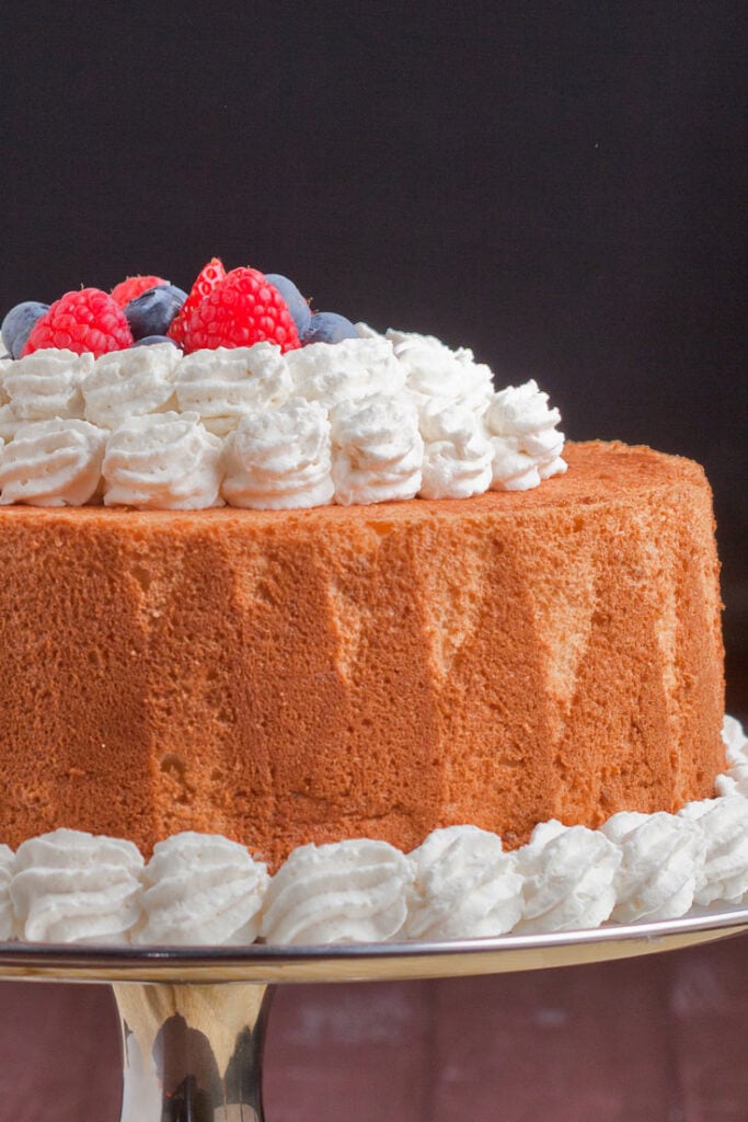 homemade angel food cake with whipped cream and berries 