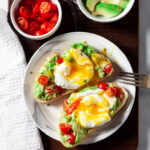 poached eggs on avocado toast on plate