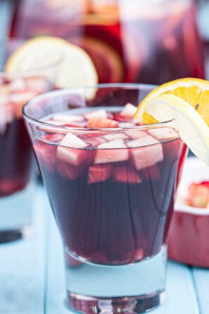 red sangria in glasses with fresh fruits
