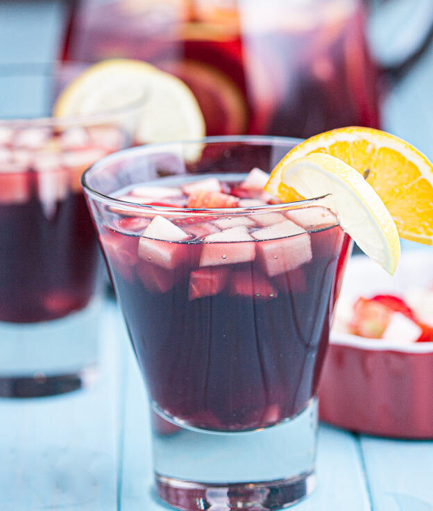 red sangria in glasses with fresh fruits