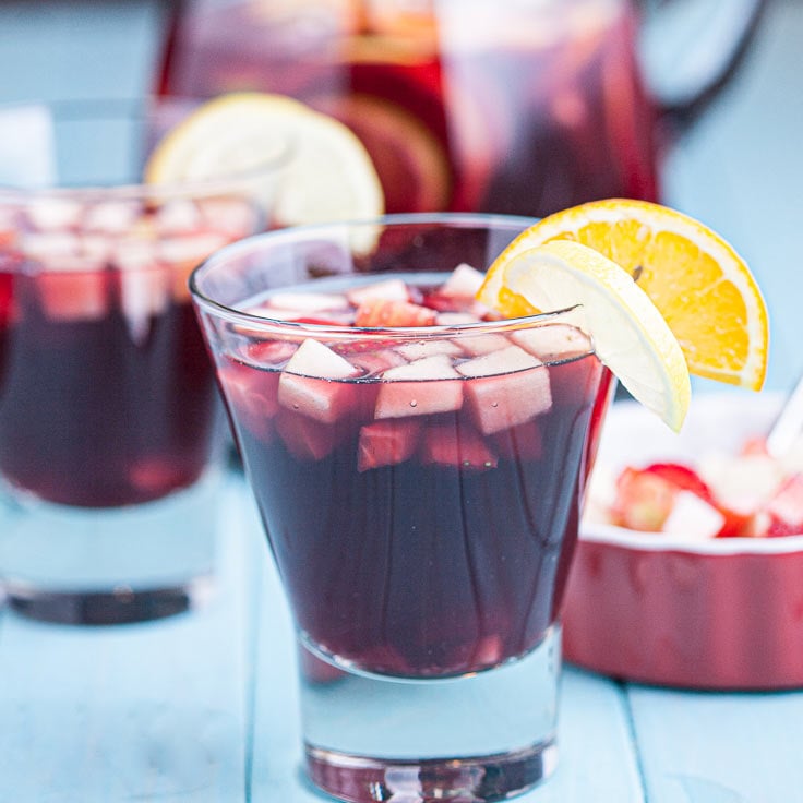 red sangria in glasses with fresh fruits