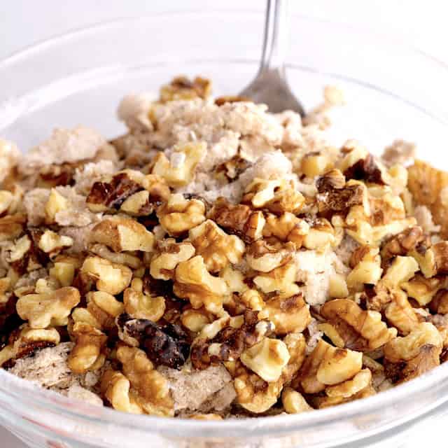 Nuts being stirred into crumbly mixture to make the best peach crisp.