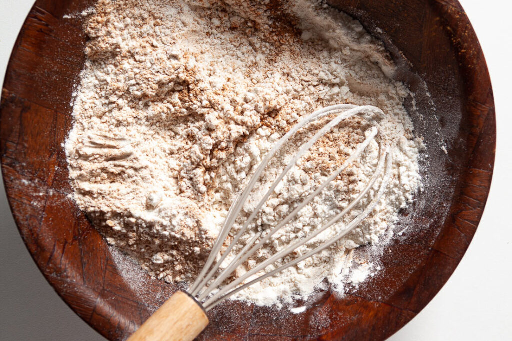 zucchini bread dry ingredients with whisk in bowl