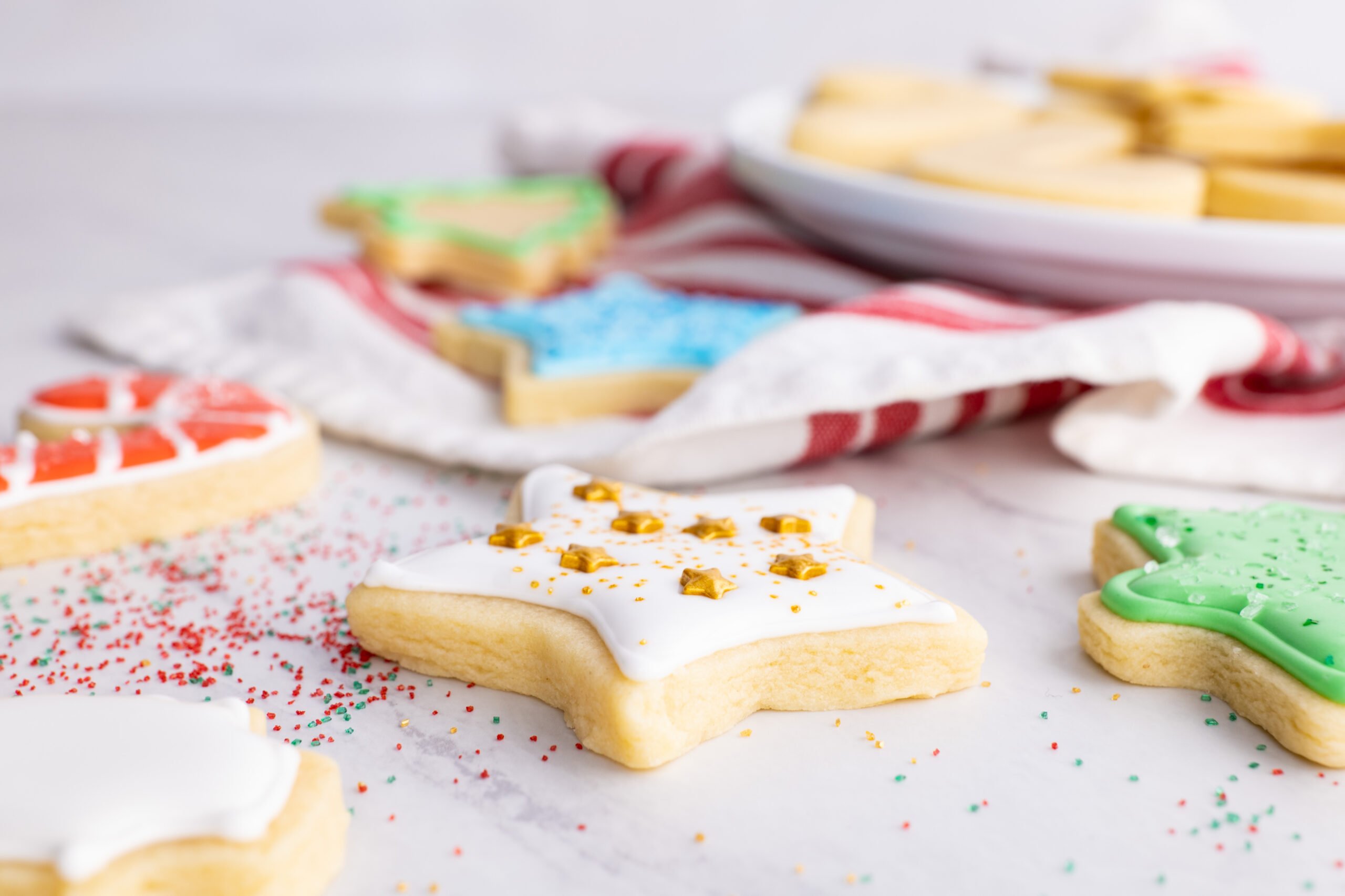 vanilla cut out cookies with icing and sprinkles