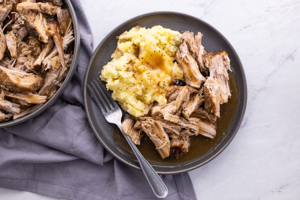 slow cooker pork loin with gravy plated.