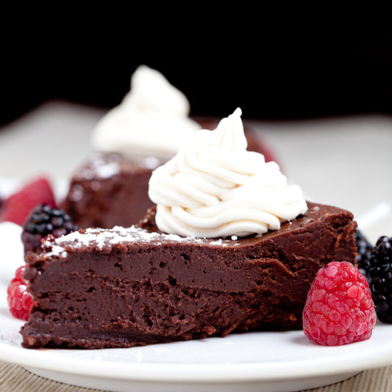 Flourless Chocolate Cake Slice with Berries and Whipped Cream