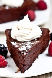 Flourless Chocolate Cake Slice with Berries and Whipped Cream