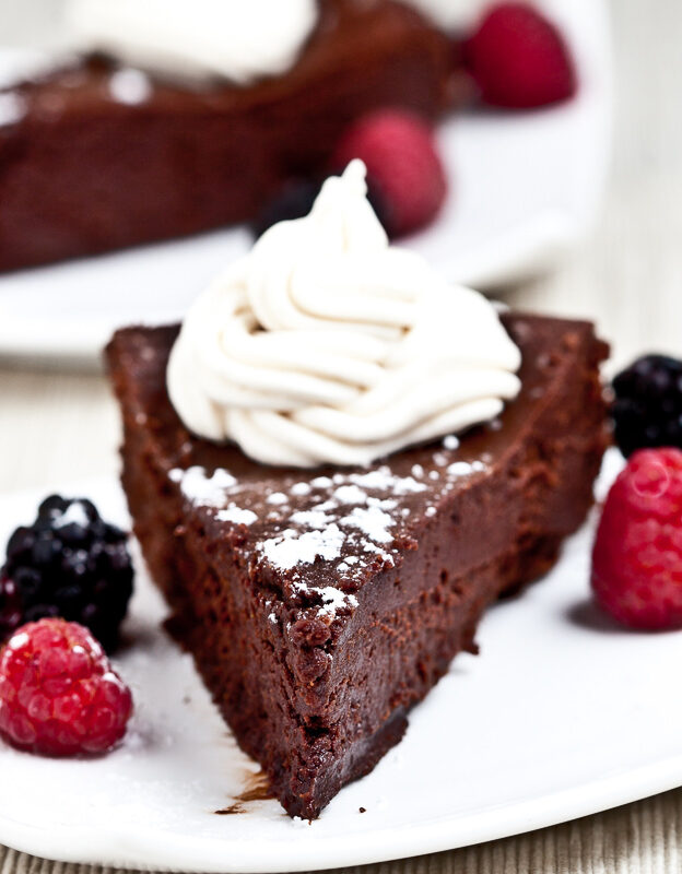 Flourless Chocolate Cake Slice with Berries and Whipped Cream