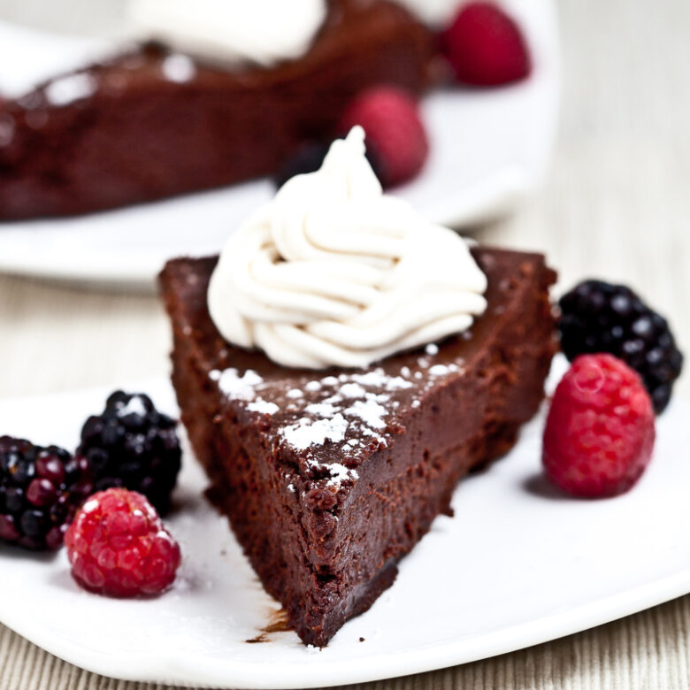 Flourless Chocolate Cake Slice with Berries and Whipped Cream