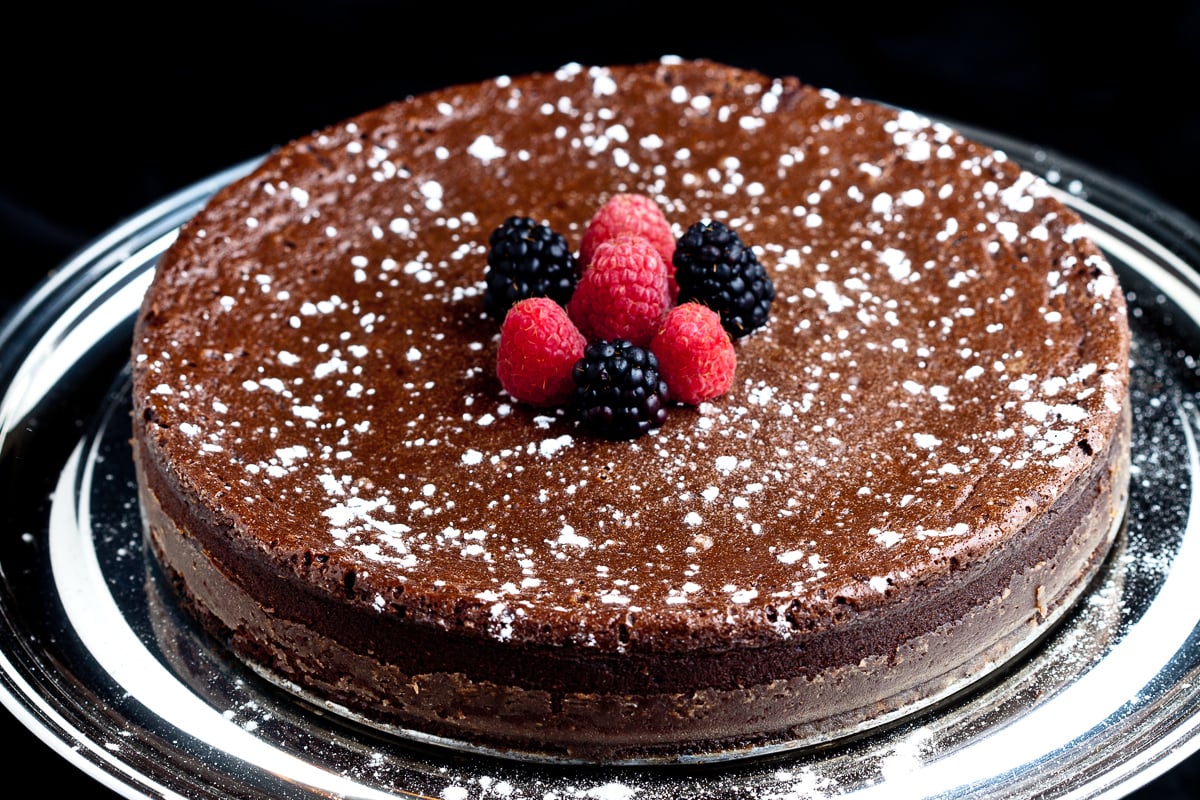 Flourless Chocolate Cake Slice with Berries on cake platter