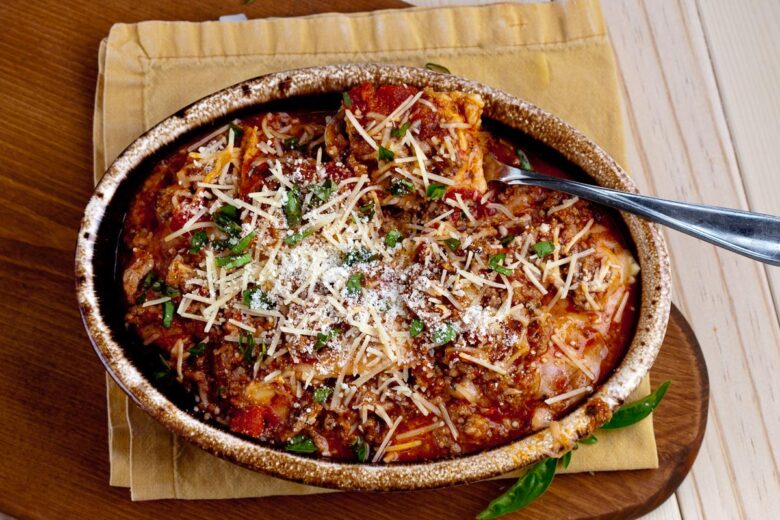 Baked ravioli casserole in oval dish horizontal shot