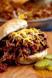 sloppy joes in bun with cheese and pickles