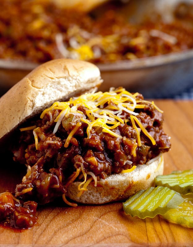 sloppy joes in bun with cheese and pickles