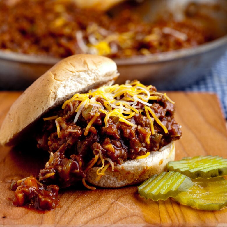 sloppy joes in bun with cheese and pickles