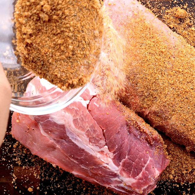 Dry rub for tender bbq ribs being pressed on both sides.
