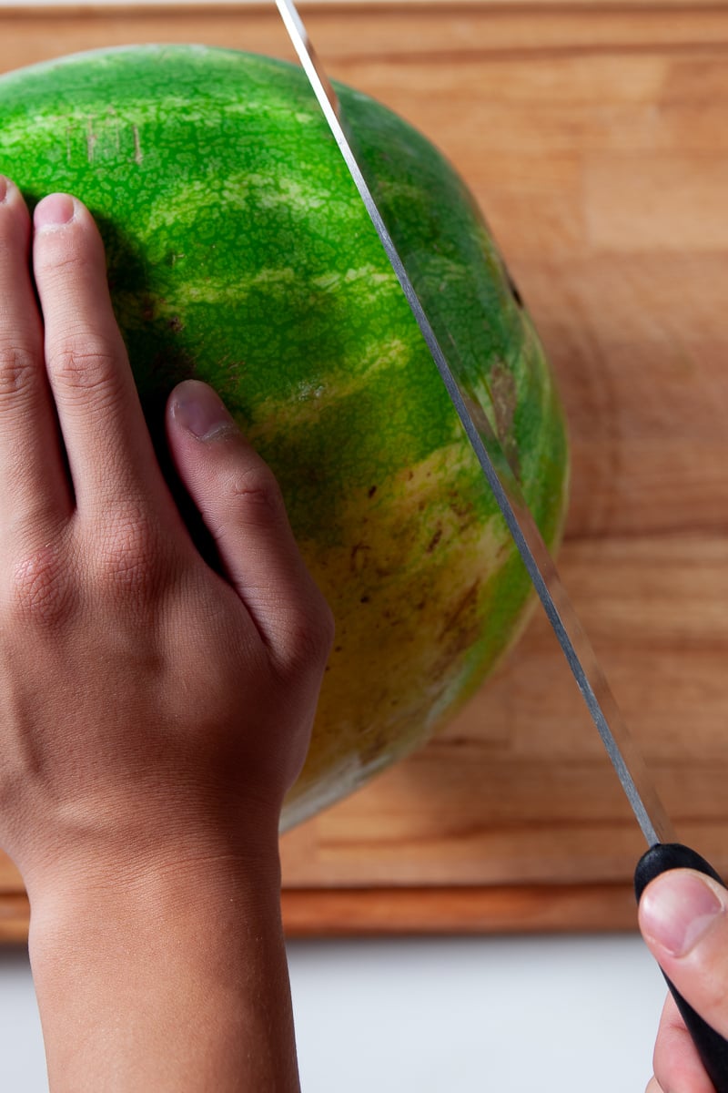 Whole watermelon being cut at end