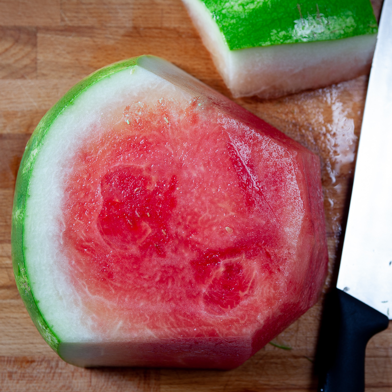 cutting watermelon rind off