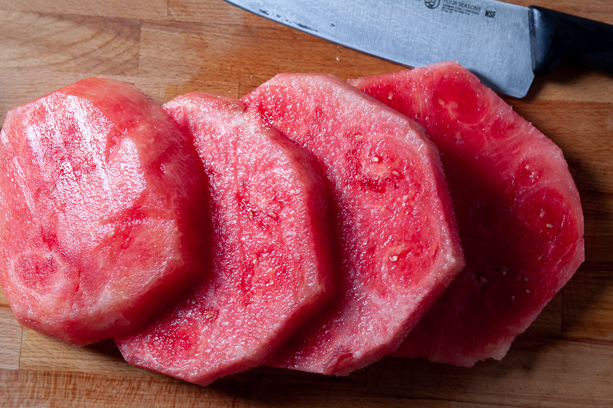 watermelon being sliced into rounds