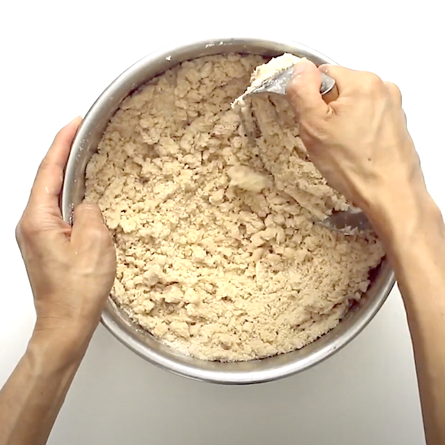 Crust and topping mixture being prepared to make blueberry crumb bars.