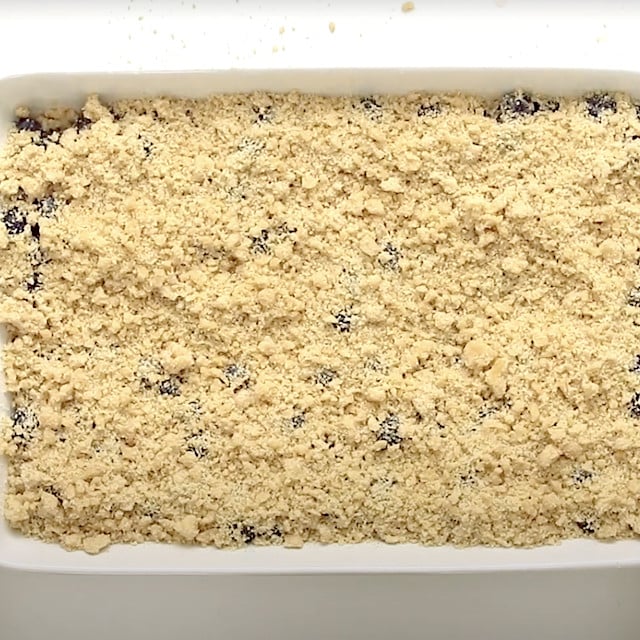 Crumb topping layered on top to make blueberry crumb bars.