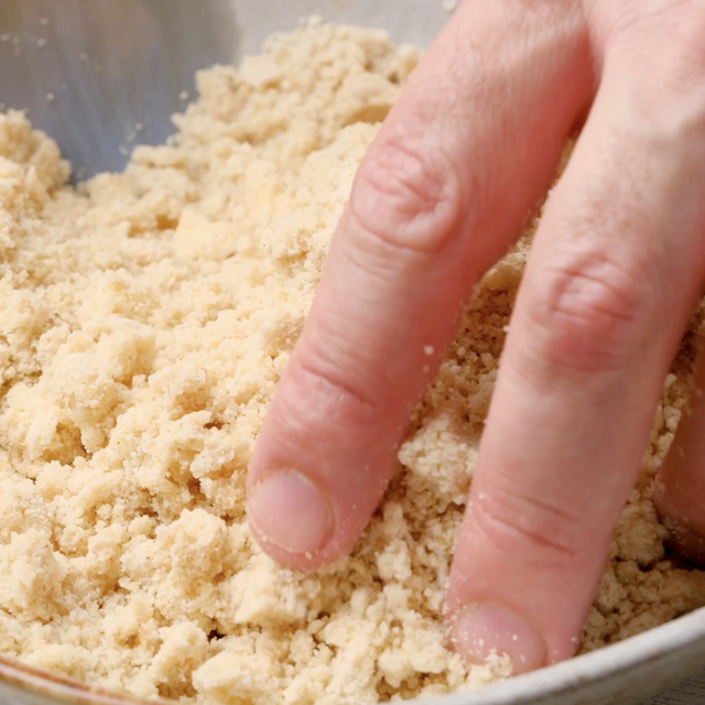 Streusel for blueberry coffee cake being mixed by hand.