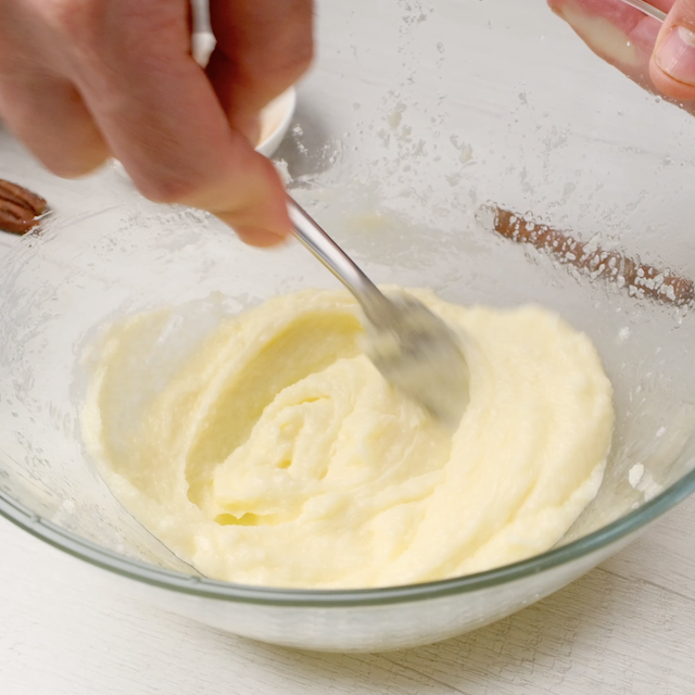 Butter and sugar being creamed together in a bowl.