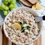 overhead image of healthy chicken salad in a bowl topped with a lemon wedge
