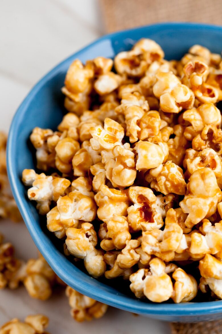 a blue bowl full of caramel popcorn