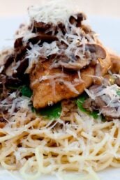 chicken marsala in a white bowl with angel hair pasta