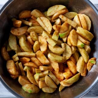 overhead image of a bowl full of cinnamon spiced sliced apples