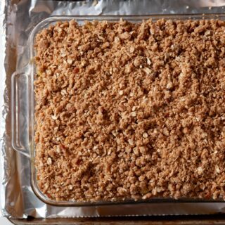 overhead image of a gluten free apple crisp in a clear baking dish