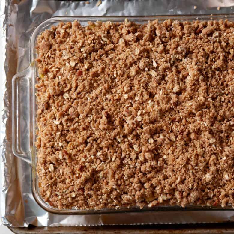 overhead image of apple crisp in a baking dish ready to go into oven.