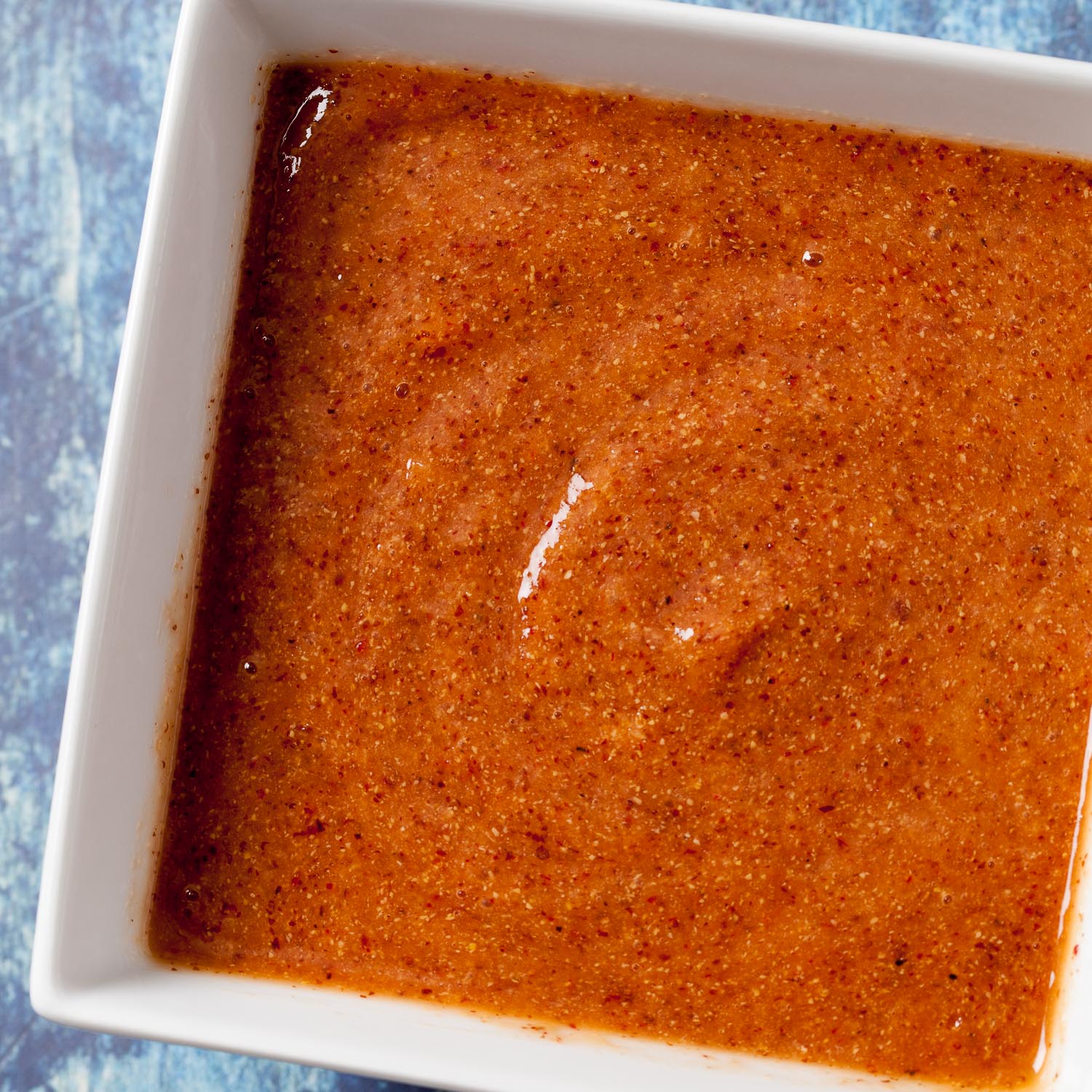 peach bbq marinade in a square white bowl