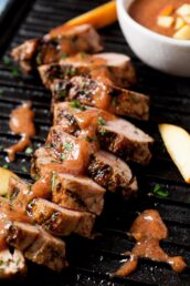 sliced grilled pork tenderloin covered with homemade peach bbq sauce