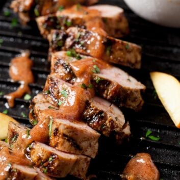 sliced grilled pork tenderloin covered with homemade peach bbq sauce