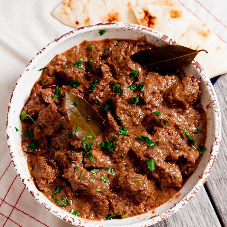 Rogan Josh in a bowl with naan bread