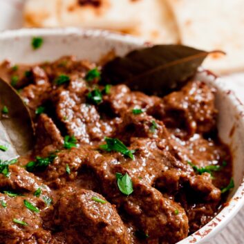 Rogan Josh in a bowl with naan bread