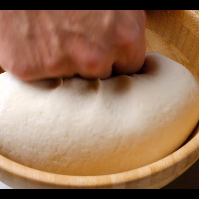 dough for scallion pancakes being kneaded.