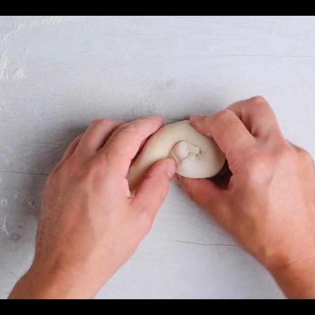 scallion pancake dough being pinwheeled.