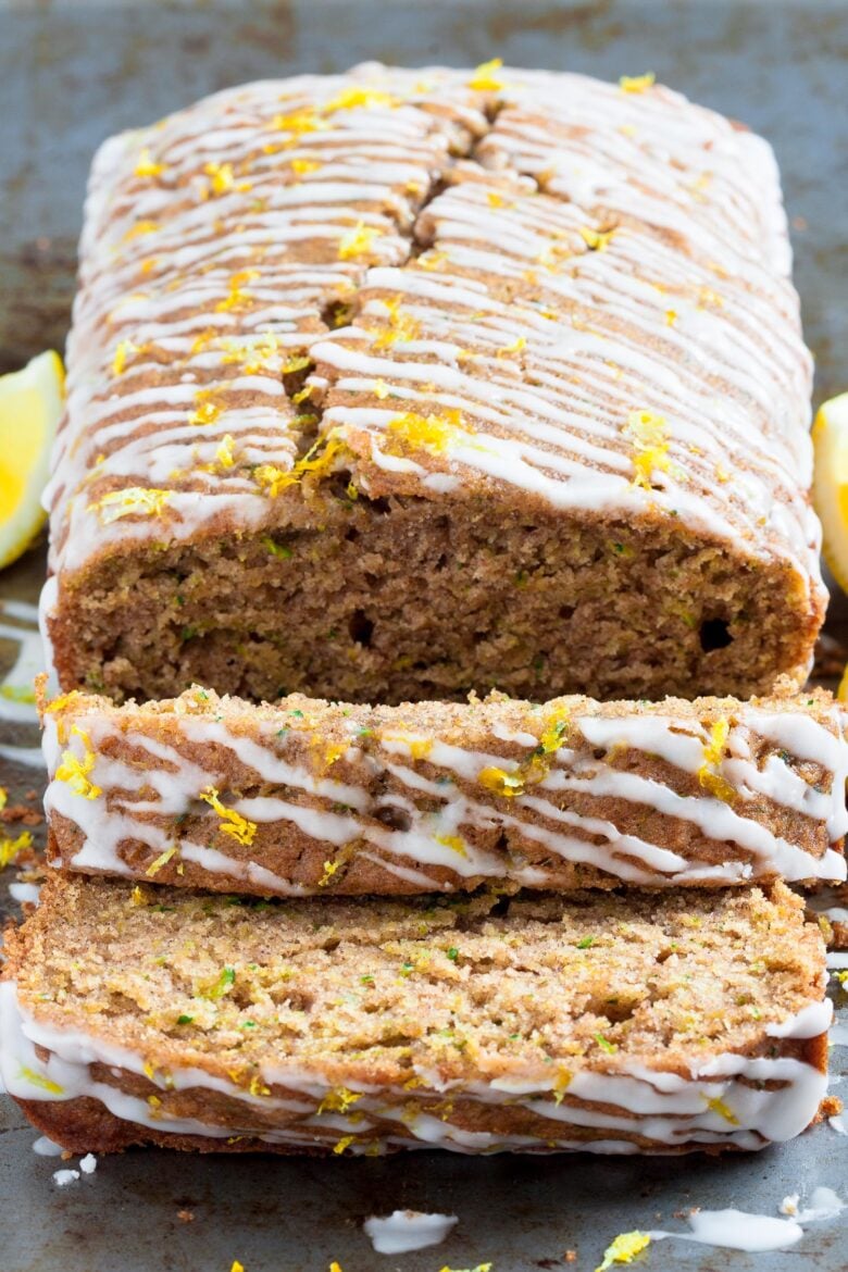 lemon zucchini bread slices with icing and lemon zest