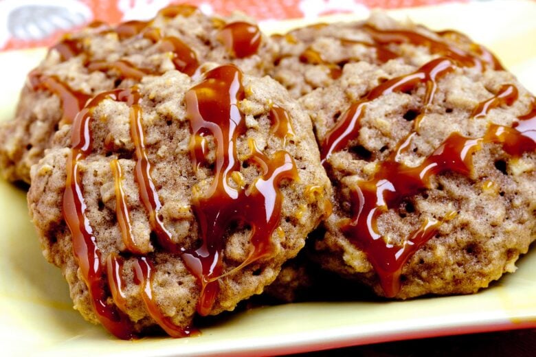 caramel drizzled apple cookies on a yellow plate