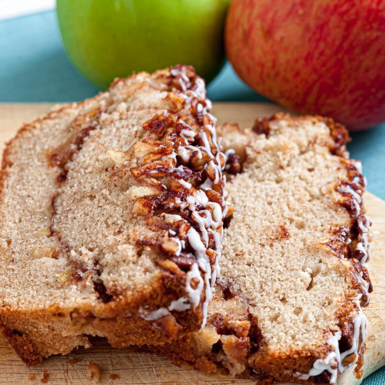 2 slices of apple streusel loaf bread on a cutting board